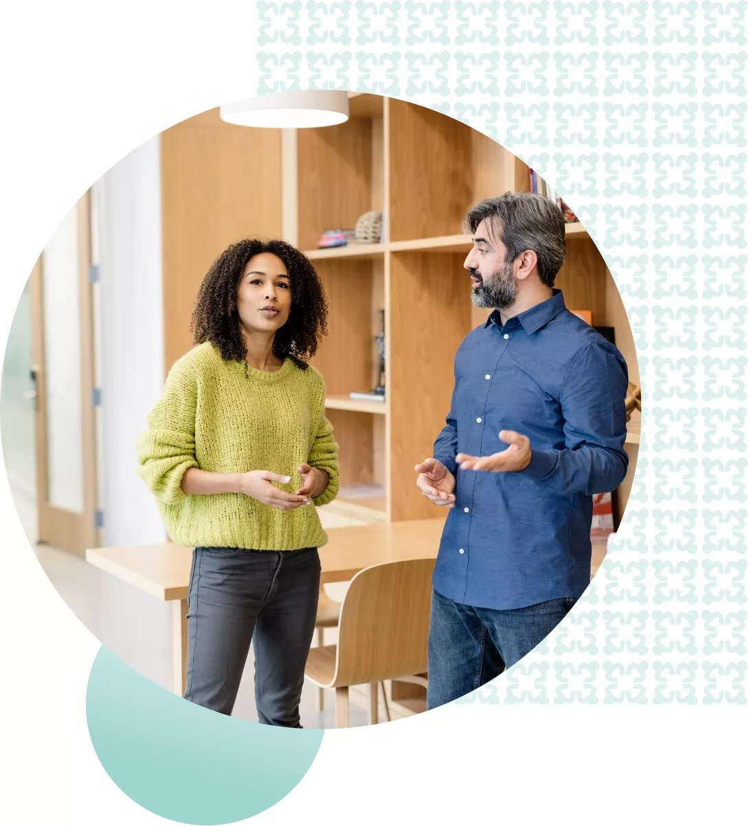 two people standing and speaking inside of a store