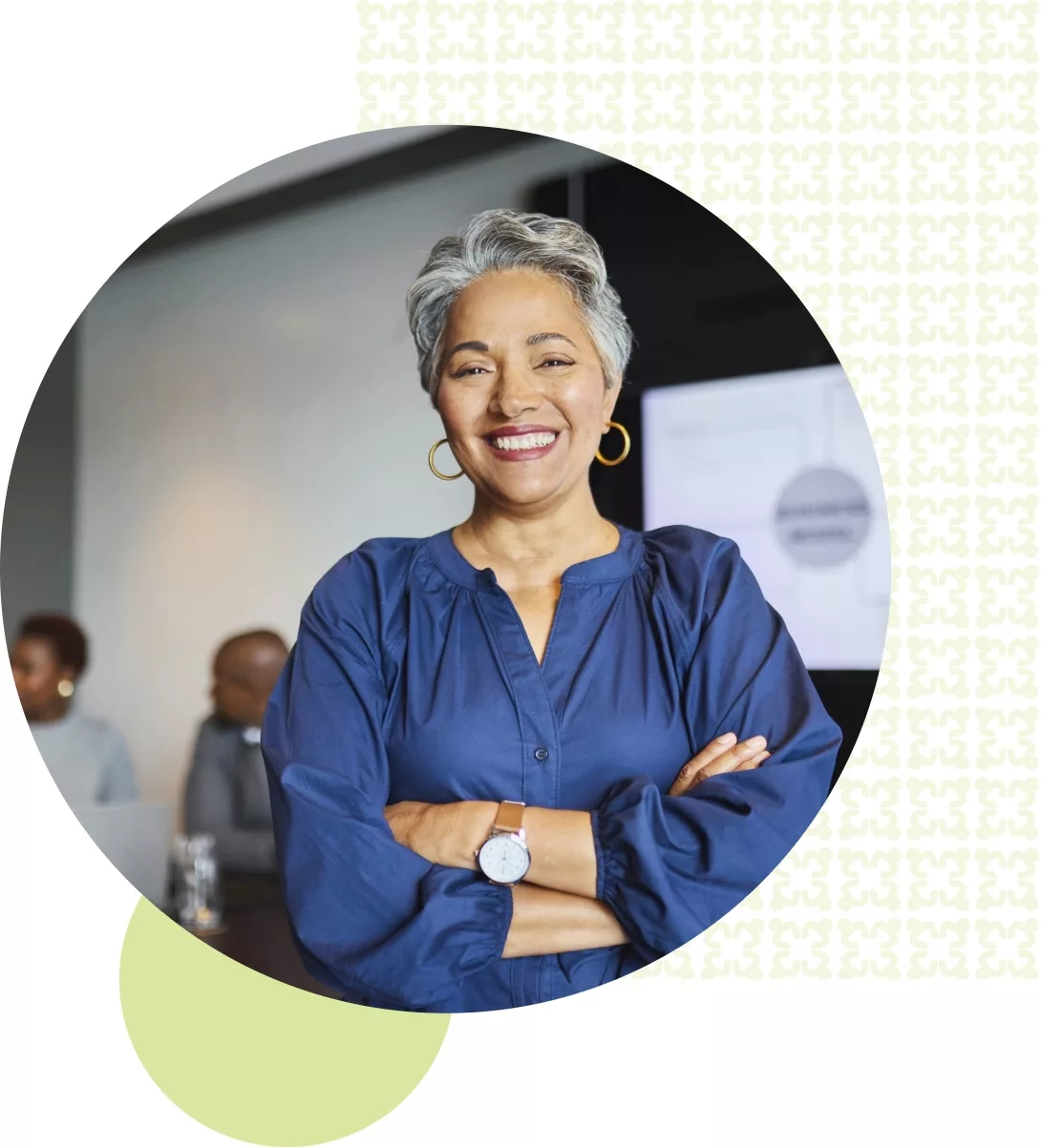 business woman in dark blue blouse smiling with her arms crossed